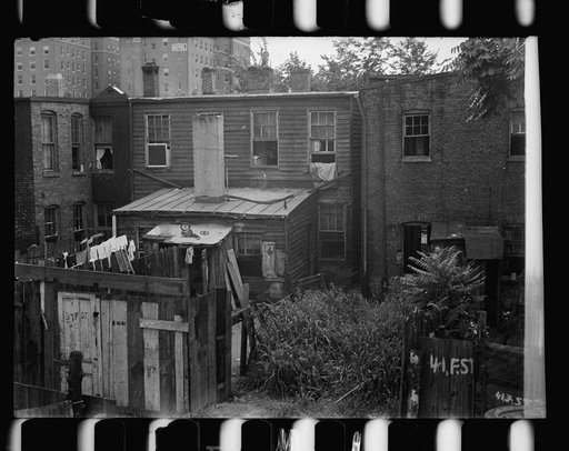 Untitled photo, possibly related to: Front of Negro home near Capitol, Washington, D.C. Interiors of these homes vary little. A chair or two and a table, a bed and perhaps an extra mattress on the floor cares for six to ten people