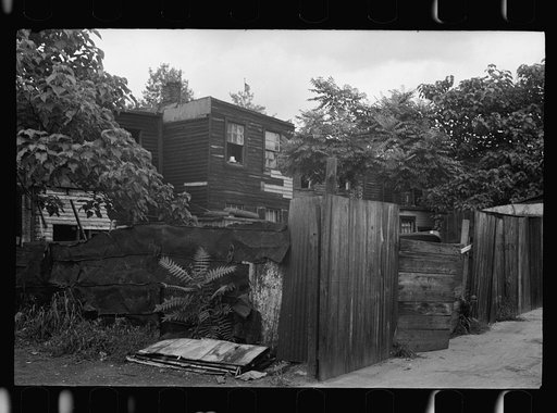 Untitled photo, possibly related to: Front of Negro home near Capitol, Washington, D.C. Interiors of these homes vary little. A chair or two and a table, a bed and perhaps an extra mattress on the floor cares for six to ten people