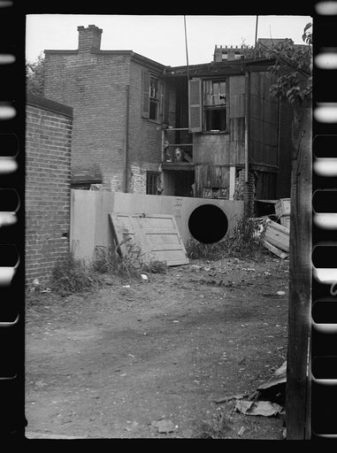Untitled photo, possibly related to: Front of Negro home near Capitol, Washington, D.C. Interiors of these homes vary little. A chair or two and a table, a bed and perhaps an extra mattress on the floor cares for six to ten people