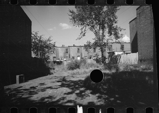 Untitled photo, possibly related to: White girls playing in slum section near Capitol inhabited mostly by Negroes. Note Capitol dome in right background. Washington, D.C.