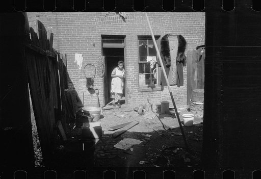 Backyard of Negro dwelling in slum area near the House office building, Washington, D.C.