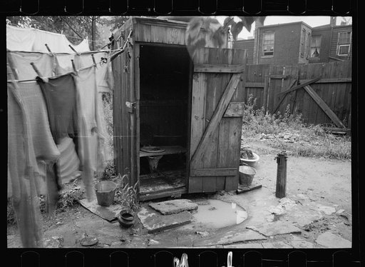 Untitled photo, possibly related to: Backyard and privy near Government Printing Office, Washington, D.C. The pump on the right supplies water for the house back of privy