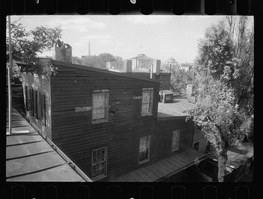Untitled photo, possibly related to: Old wooden shacks on left of picture inhabited by whites and Negroes. Many of these houses have no inside water supply or toilet. Washington, D.C.
