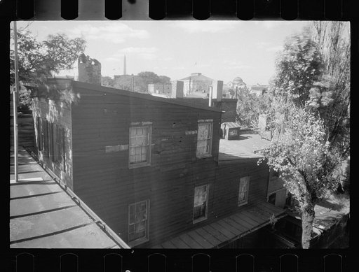 Untitled photo, possibly related to: Old wooden shacks on left of picture inhabited by whites and Negroes. Many of these houses have no inside water supply or toilet. Washington, D.C.