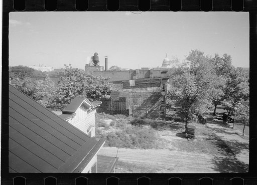 Untitled photo, possibly related to: Old wooden shacks on left of picture inhabited by whites and Negroes. Many of these houses have no inside water supply or toilet. Washington, D.C.