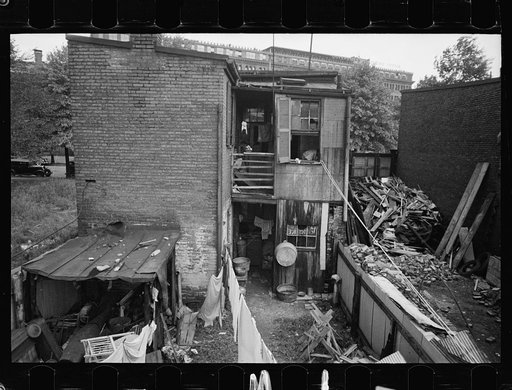 Untitled photo, possibly related to: Children in slum area, Washington, D.C. Children in their backyard in a slum area near the Capitol. This area inhabited by both black and white
