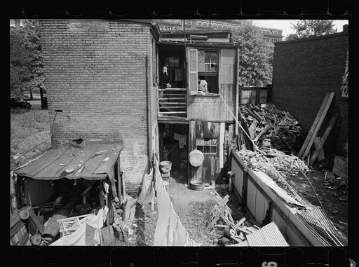 Untitled photo, possibly related to: Children in slum area, Washington, D.C. Children in their backyard in a slum area near the Capitol. This area inhabited by both black and white