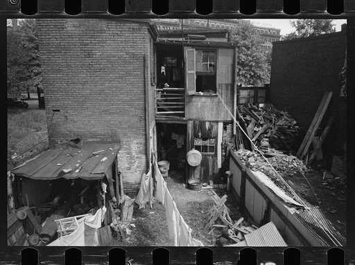 Untitled photo, possibly related to: Children in slum area, Washington, D.C. Children in their backyard in a slum area near the Capitol. This area inhabited by both black and white