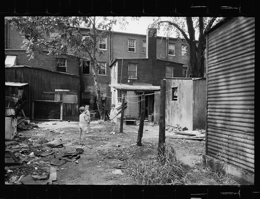 Children in slum area, Washington, D.C. Children in their backyard in a slum area near the Capitol. This area inhabited by both black and white