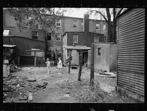 Untitled photo, possibly related to: Children in slum area, Washington, D.C. Children in their backyard in a slum area near the Capitol. This area inhabited by both black and white