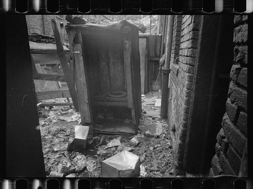 Untitled photo, possibly related to: Privy near Capitol, Washington, D.C. This outbuilding leaks and drains on land about it. Negro inhabitants appear oblivious to it all. No door to this privy, but a sheet of canvas which is seldom used