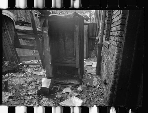 Untitled photo, possibly related to: Privy near Capitol, Washington, D.C. This outbuilding leaks and drains on land about it. Negro inhabitants appear oblivious to it all. No door to this privy, but a sheet of canvas which is seldom used