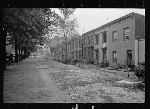 Section of Massachusetts Avenue showing block of shabby houses with outside toilets and water supply, Washington, D.C.