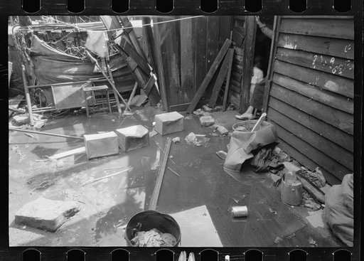 Untitled photo, possibly related to: Negro backyard, Washington, D.C. Backyard near Stratford Hotel and within short distance from both the Capitol and Union Station, showing flooded yard and debris. In big rains, kitchen and bedroom floors of this house are so flooded that it is necessary to lay pl