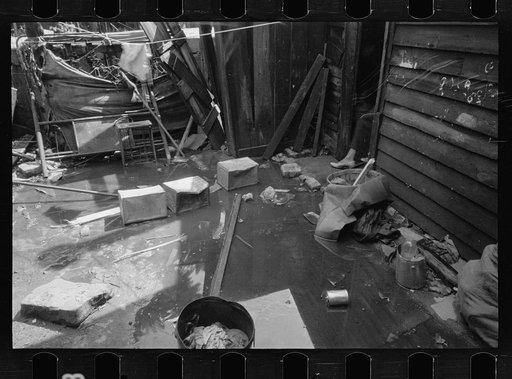 Untitled photo, possibly related to: Negro backyard, Washington, D.C. Backyard near Stratford Hotel and within short distance from both the Capitol and Union Station, showing flooded yard and debris. In big rains, kitchen and bedroom floors of this house are so flooded that it is necessary to lay pl