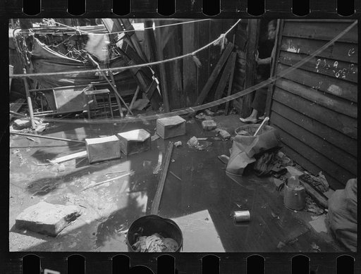 Untitled photo, possibly related to: Negro backyard, Washington, D.C. Backyard near Stratford Hotel and within short distance from both the Capitol and Union Station, showing flooded yard and debris. In big rains, kitchen and bedroom floors of this house are so flooded that it is necessary to lay pl