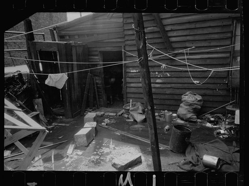 Untitled photo, possibly related to: Negro backyard, Washington, D.C. Backyard near Stratford Hotel and within short distance from both the Capitol and Union Station, showing flooded yard and debris. In big rains, kitchen and bedroom floors of this house are so flooded that it is necessary to lay pl