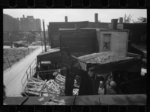 Untitled photo, possibly related to: Negro backyard, Washington, D.C. Backyard near Stratford Hotel and within short distance from both the Capitol and Union Station, showing flooded yard and debris. In big rains, kitchen and bedroom floors of this house are so flooded that it is necessary to lay pl
