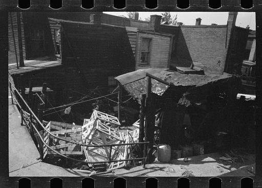Untitled photo, possibly related to: Negro backyard, Washington, D.C. Backyard near Stratford Hotel and within short distance from both the Capitol and Union Station, showing flooded yard and debris. In big rains, kitchen and bedroom floors of this house are so flooded that it is necessary to lay pl