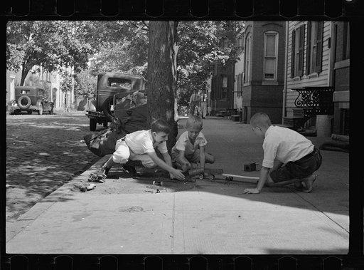 Children playing on sidewalk, the only available playground. Georgetown, inhabited by both white and Negro, Washington, D.C.