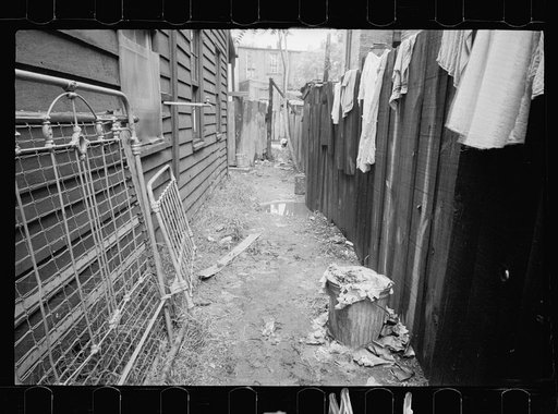 Typical back alley in one of the many Washington slums, Washington, D.C.  This house is located close to the Capitol