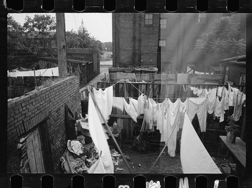 Untitled photo, possibly related to: The Capitol can be seen in the background of this backyard slum scene, Washington, D.C.