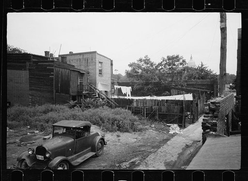 Untitled photo, possibly related to: Typical slum area. Note dome of Capitol, Washington, D.C.