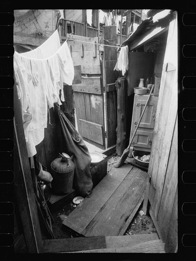 Backyard of house near the House office building, showing privy on extreme right with water supply between privy and ice box. This is an alley dwelling and these tiny, overcrowded, dirty backyards are characteristic of this section