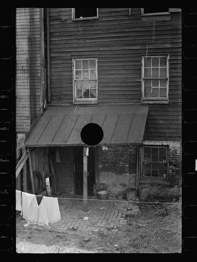 Untitled photo, possibly related to: Typical slum area. Note dome of Capitol, Washington, D.C.