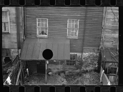 Untitled photo, possibly related to: Typical slum area. Note dome of Capitol, Washington, D.C.