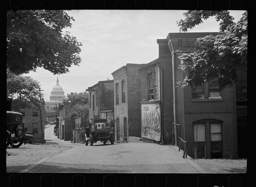Slums near the Capitol, Washington, D.C. With the Capitol clearly in view, these houses exist under the most unsanitary conditions; outside privies, no inside water supply and overcrowded conditions
