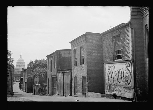 Untitled photo, possibly related to: Slums near the Capitol, Washington, D.C. With the Capitol clearly in view, these houses exist under the most unsanitary conditions; outside privies, no inside water supply and overcrowded conditions