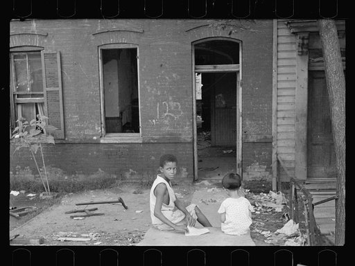Slum front yard playground, Washington, D.C. Such is the front yard available to these two youngsters to play in