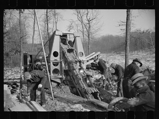 A model community planned by the Suburban Division of the U.S. Resettlement Administration. Mechanical digger opening a sewer line, Greenbelt, Maryland