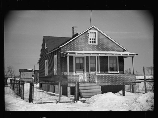 Cheap false brick tarpaper-covered wooden house typical of subdivision sections in Franklin Township, Amwell Road, West New Brunswick near Derussey land, New Jersey