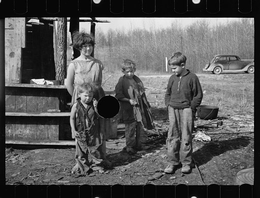 Untitled photo, possibly related to: Twelve-year old girl of family of nine living in one-room hut built over the chassis of abandoned Ford truck in open field on U.S. Route 70 between Camden and Bruceton, Tennessee. Near backward Tennessee section. View also shows one of the small boys in family; t