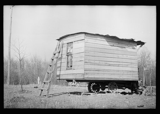 Untitled photo, possibly related to: This one-room hut built of rough lumber over the chassis of an abandoned Ford truck was the housing provided by a landlord for an illiterate wood-cutter, with a wife and seven children. Found on U.S. Route 70 between Camden and Bruceton, Tennessee, near Tennessee