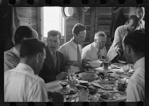 Resettlement officials eating in the mess hall at Greenbelt, Maryland
