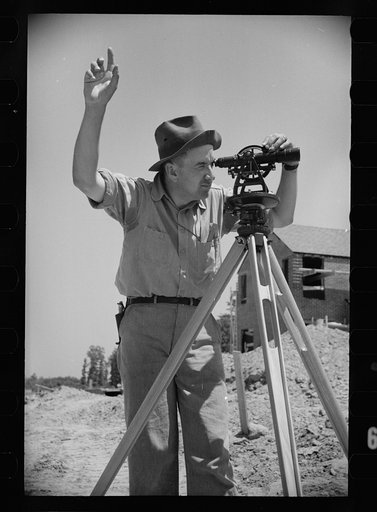 Surveyor at Greenbelt, Maryland, working in a model community planned by the Surburban Division of the United States Resettlement Administration