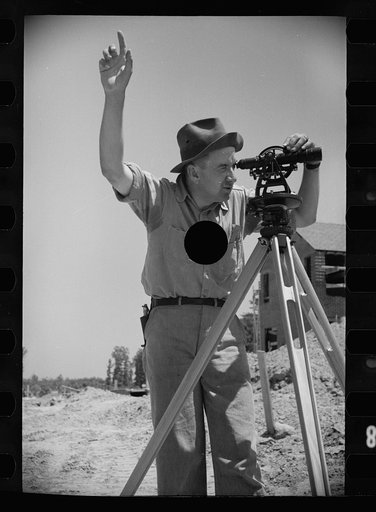 Untitled photo, possibly related to: Surveyor at Greenbelt, Maryland, working in a model community planned by the Surburban Division of the United States Resettlement Administration