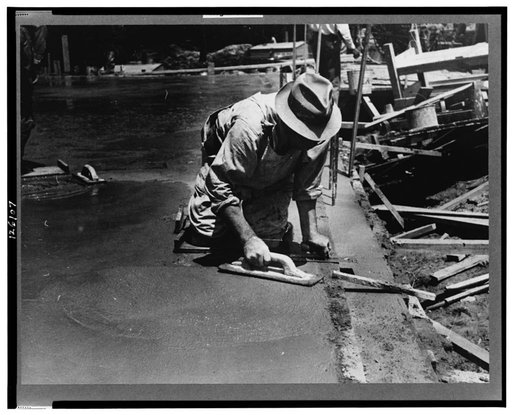 Worker leveling cement floor, Greenbelt, Maryland
