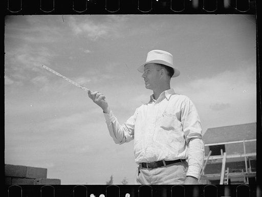 Untitled photo, possibly related to: Surveyor working in a model community planned by the Suburban Division of the United States Resettlement Administration, Greenbelt, Maryland