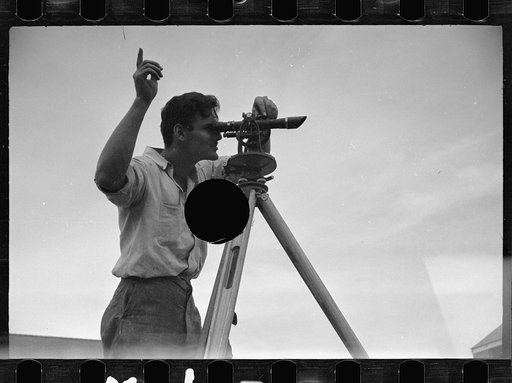 Untitled photo, possibly related to: Surveyor working in a model community planned by the Suburban Division of the United States Resettlement Administration, Greenbelt, Maryland