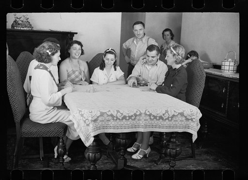 Untitled photo, possibly related to: Family group playing cards in one of the new homes on the Hightstown Project, New Jersey
