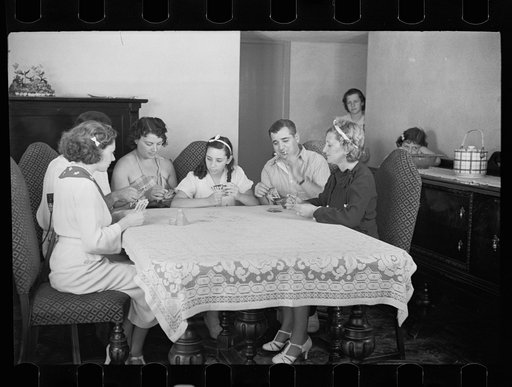 Untitled photo, possibly related to: Family group playing cards in one of the new homes on the Hightstown Project, New Jersey