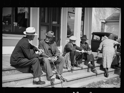 Untitled photo, possibly related to: Fair at Albany, Vermont. The old timers take to the steps of the general store