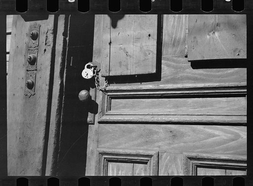Padlocked doors on tenement houses are not uncommon in the French section with mills closed down, Amoskeag, Manchester, New Hampshire