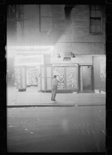 Untitled photo, possibly related to: Putting up movie posters at night, Washington, D.C.