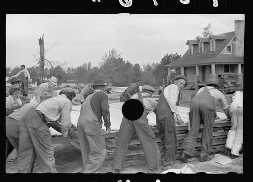 Untitled photo, possibly related to: Loading wall of prefabricated house onto truck, Roanoke Farms, North Carolina