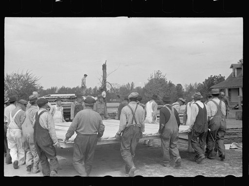 Loading wall of prefabricated house onto truck, Roanoke Farms, North Carolina